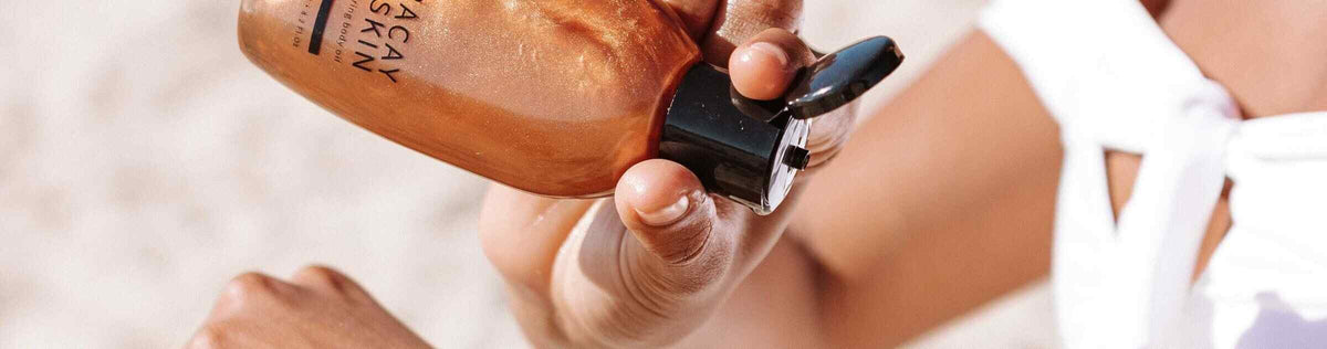 Woman applying body oil to arm