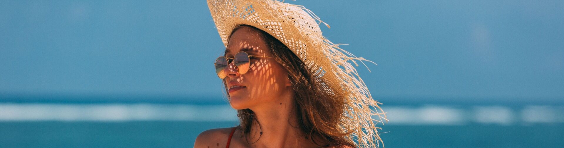 tanned woman sitting at the beach